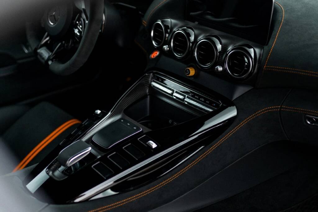 Sports car interior with round air vents and center console controls