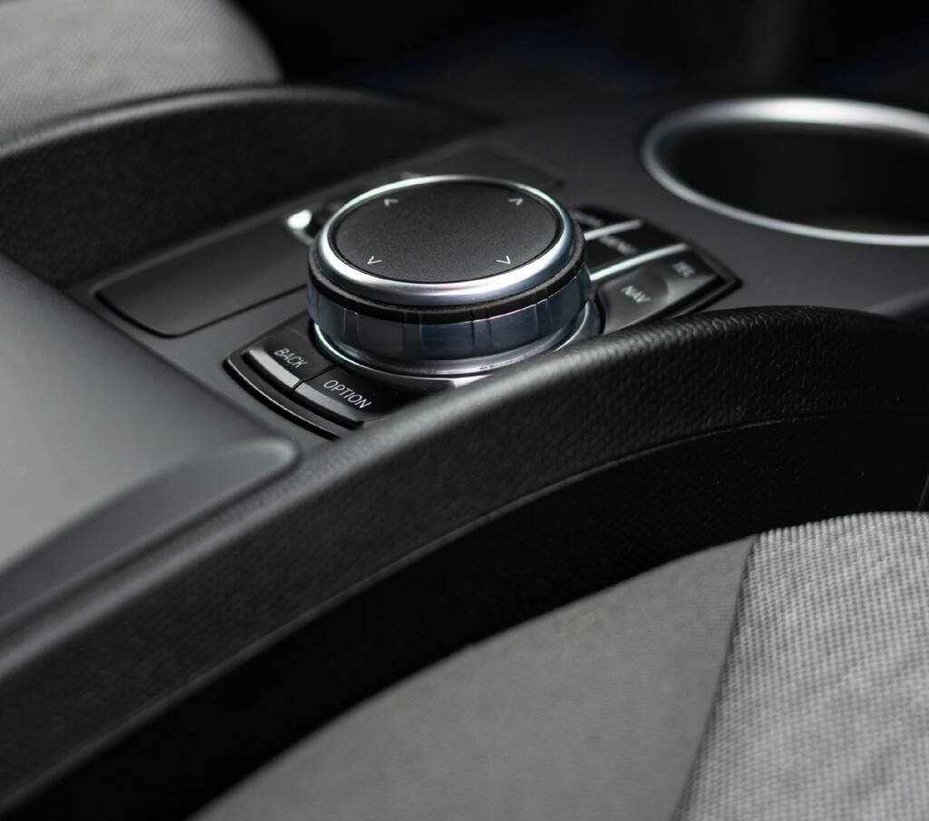 Rotary infotainment controller and cupholders in a luxury car